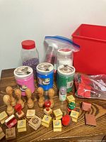 Overview of sand jars, glitter and many teacher stamps on table