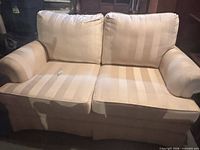 Front view of cream loveseat with cushions