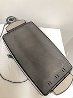 Top view of appliance with flat griddle side up, power cord and control dial visible