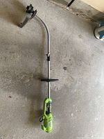 Full view of Greenworks corded electric string trimmer showing handle, shaft, spool guard