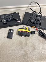 Two disc players, streaming box, accessories and Flip camera laid out
