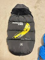 Full view of sleeping bag showing hood, banana print, text and zipper
