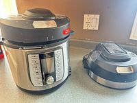 Multi-cooker with both lids on countertop