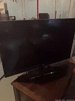 Front view of LG 55-inch flatscreen TV on stand