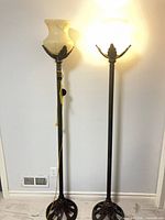 Full view of both matching floor lamps, one illuminated, showing height and overall design