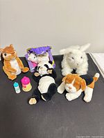 Group shot of five plush animals and two bottles