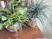 Both artificial arrangements side by side on wooden surface