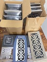 Two boxes containing multiple register covers plus packaged set and single cover displayed