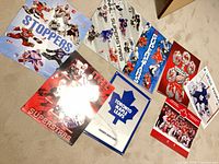 All eight posters laid out on floor for overview