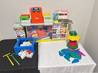 Boxed Little Tikes Microscope Science Set, Tippin' Toadstool components, Don’t Break The Ice parts grouped on table