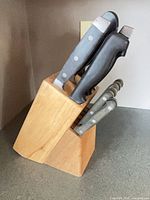 Side view of wooden block with knives inserted