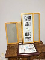 Four of the wooden frames displayed on a dresser, showing light and dark wood finishes and relative sizes