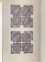 Both metal wall art panels mounted vertically on wall