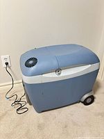 Full view of blue/grey Mobicool W45 cooler plugged in