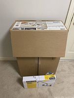 Sealed boxes of Blanco sink and Facto faucet stacked