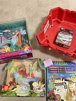 All five items: Ariel Salon box, red Beyblade stadium with Grip Attacker box, Tinker Bell playset box, Hannah Montana activity set
