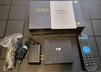 Full lot showing TV box, remote, power adapter, HDMI cable, telephone cable, user manual and original packaging