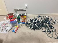 Lot overview with five light strings, spare bulbs in bags and boxes, and plastic clips