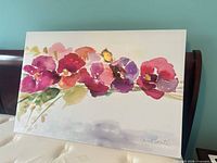 Front of floral canvas painting on mattress