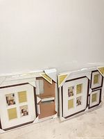 Two large and two smaller boxed wooden photo frames