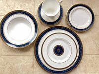 Dinner plate, bread plate, soup bowl, cup and saucer showing pattern and trim
