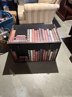 Front view of chest showing faux book design and latches