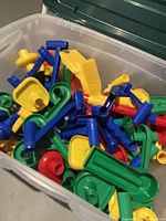 Loose Marbleworks parts in clear tote