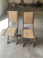 Pair of folding chairs standing unfolded in garage