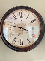 Front view of round French Provincial style wall clock