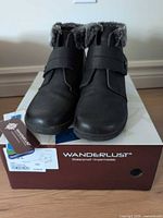 Front view of both boots on original Wanderlust box with tag visible