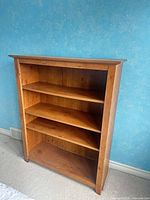 Front view of full bookcase showing shelves and overall finish