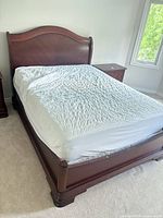 Full view of queen sleigh bed with mattress