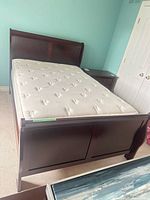Full view of sleigh bed frame with mattress