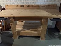 Front view of full wood workbench with backboard