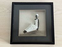 Front view of square framed shadowbox laying flat