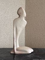 Front view of abstract stone figure sculpture showing full form