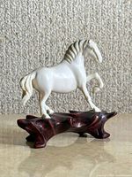 Full view of bone horse on wooden stand