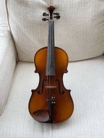 Front view of violin showing body and detached fingerboard