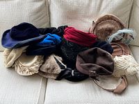 Group of twelve assorted vintage hats on sofa