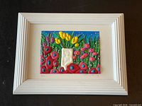Front view of framed mixed-media floral artwork