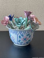 Front view of ceramic planter with multicolored ceramic flowers