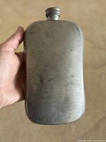 Front view of pewter pocket flask showing overall form and cap