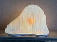 Front view of opaline iceberg lamp illuminated