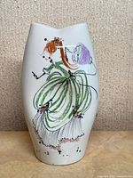 Front view showing girl with umbrella artwork on vase