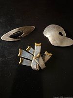 Front view of three sterling brooches