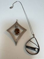 Both pendants together showing overall forms and size comparison