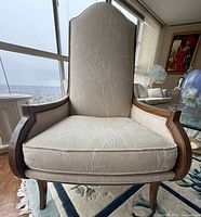 Front view of high back lounge chair showing upholstery and frame