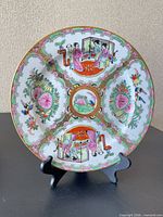 Front view of porcelain rose medallion plate on stand