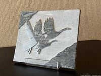 Front view of stone plaque showing flying geese relief