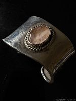Front view of sterling cuff with pink cabochon